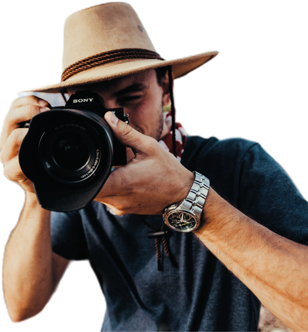 Male with a hat using a camera